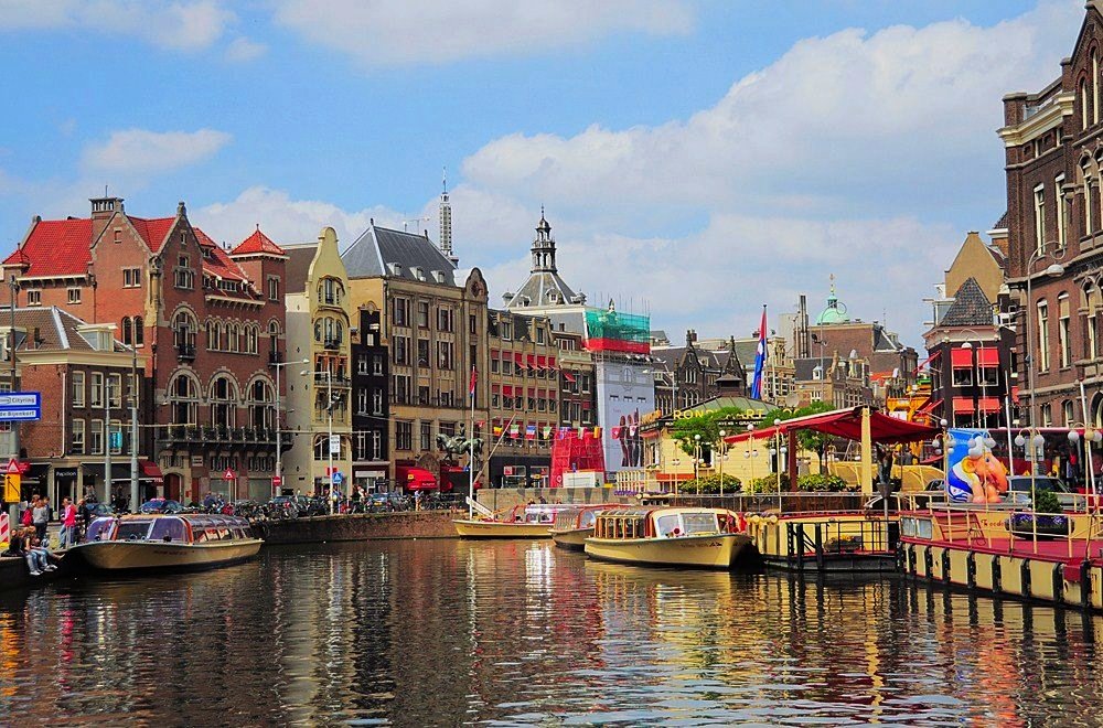 Colourful buildings of Amsterdam overlooking the canal​