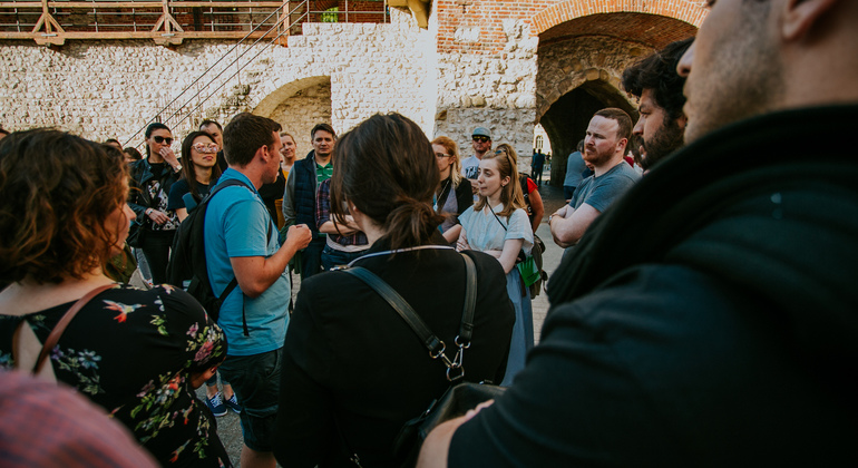 A group of tourists on a free walking tour in Krakow with their local tour guide