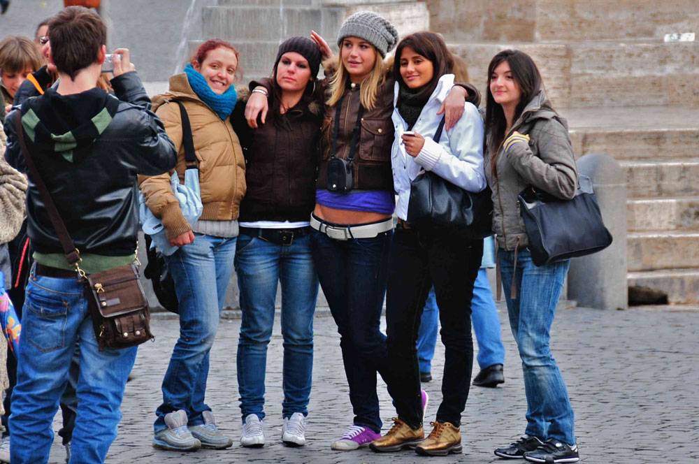 Tourists at Piazza del Popolo after walking tour in Rome, Italy