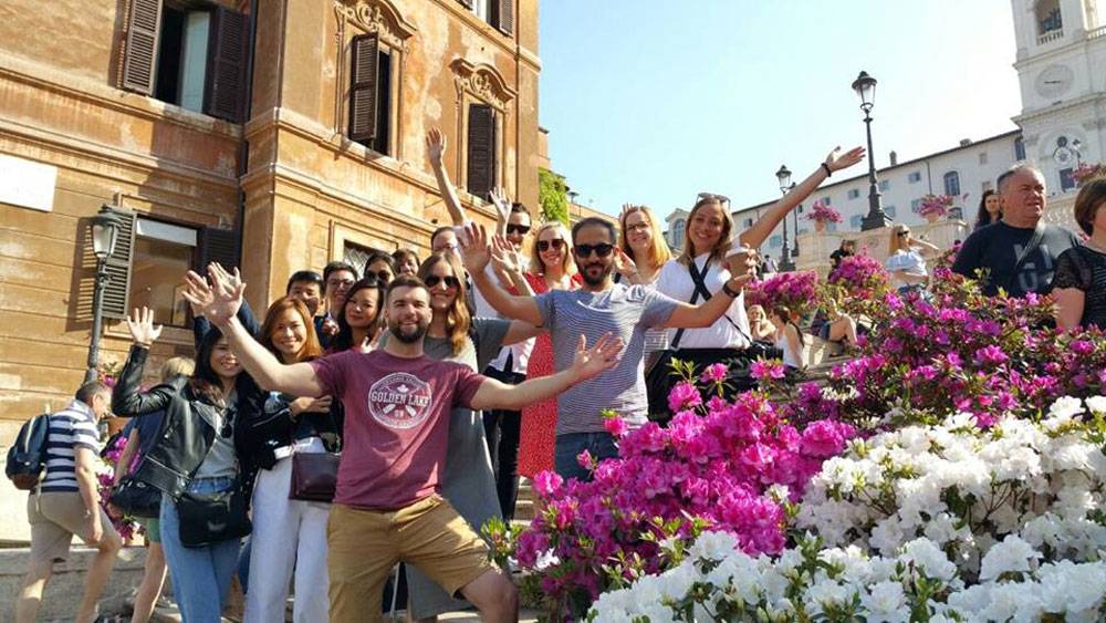 Group of young people enjoying a free city tour in Rome, Italy